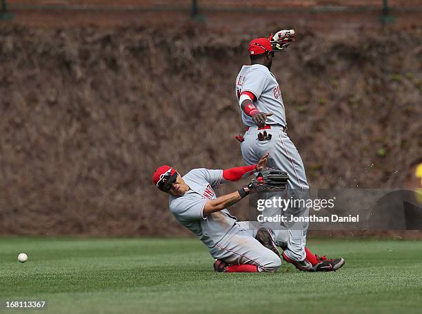 Shin-Soo Choo and Brandon Phillips of the Cincinnati Reds collide after trying to catch a ball hit by Alfonso Soriano of the Chicago Cubs at Wrigley...