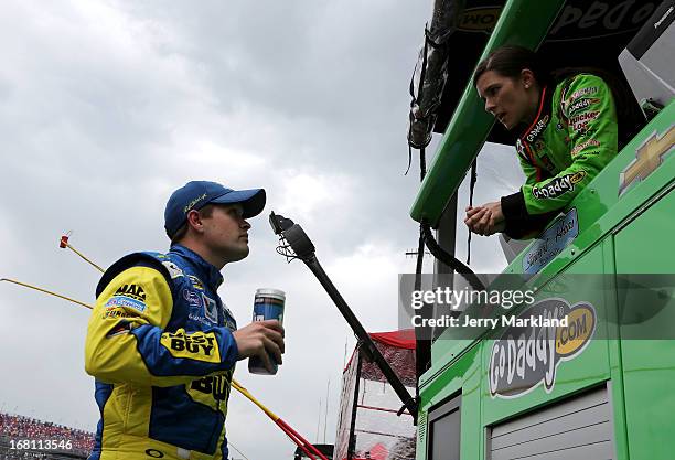 Danica Patrick , driver of the GoDaddy.com Chevrolet talks with Ricky Stenhouse Jr., driver of the Best Buy Ford, as the race was under caution due...