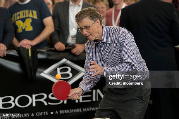 Bill Gates, chairman and founder of Microsoft Corp., returns a ball during a table tennis match with Ariel Hsing, a U.S. Table tennis player, outside...