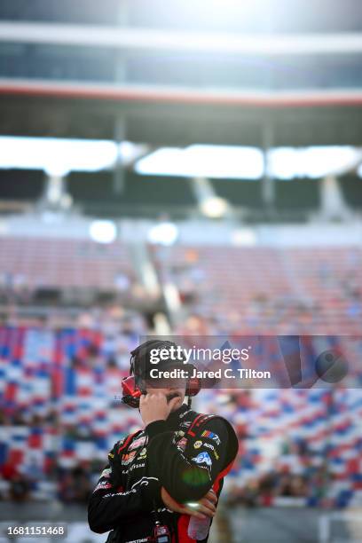 Christian Eckes, driver of the Gates Hydraulics Chevrolet, looks on during qualifying for the NASCAR Craftsman Truck Series UNOH 200 presented by...