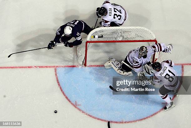 Edgars Masalskis , goaltender of Latvia makes a save on Craig Smith of USA during the IIHF World Championship group H match between Latvia and USA at...