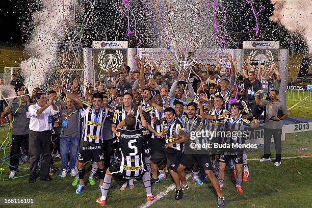 Players of Botafogo celebrate after winning the Rio State Championship 2013 at Raulino de Oliveira Stadium on May 05, 2013 in Volta Redonda, Brazil.