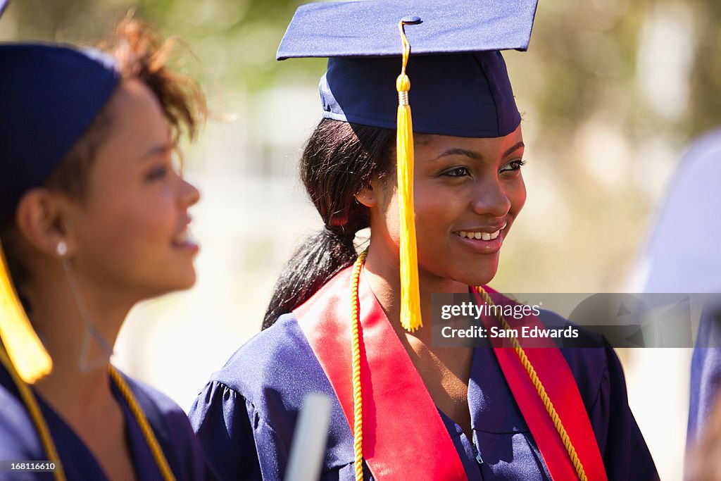 Graduates smiling in cap and gown