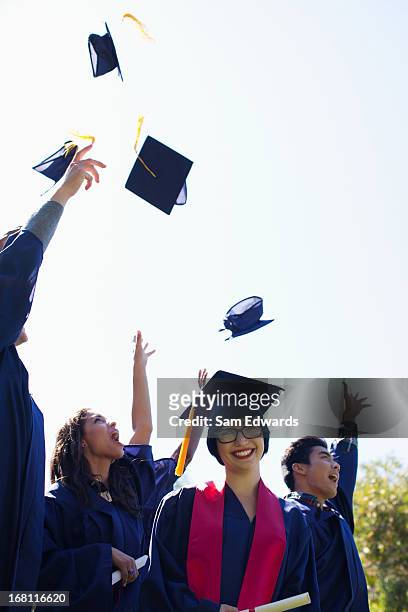 graduates throwing caps in air outdoors - animated graduation cap stock pictures, royalty-free photos & images