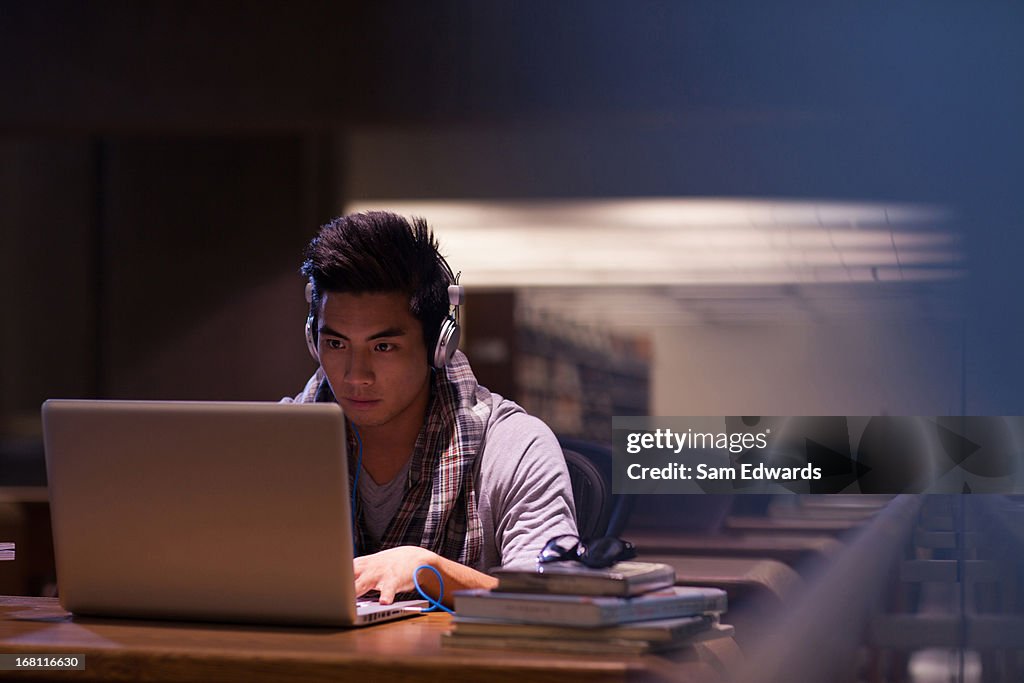 Student working on laptop in library