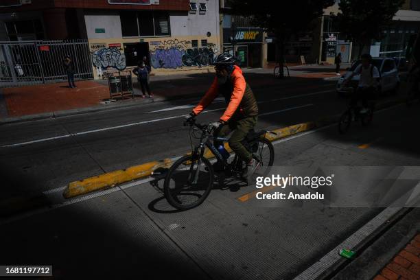 Man rides his bike on the street during the Car Free Day when only buses and taxis are allowed in Bogota, Colombia on September 21, 2023. According...