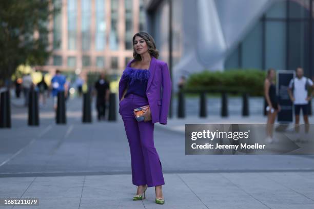 Olga Ferrara is seen wearing silver earrings with green diamonds; a matching outfit from Milly in purple, consisting of a blazer with shoulder pads...