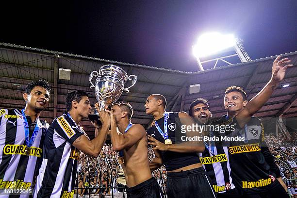 Players of Botafogo celebrate after winning the Rio State Championship 2013 at Raulino de Oliveira Stadium on May 05, 2013 in Volta Redonda, Brazil.