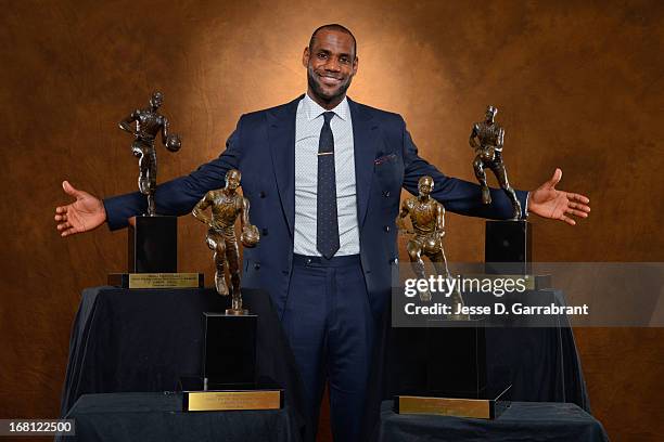 LeBron James of the Miami Heat poses with his collection of Maurice Podoloff Trophies after being named the 2012-2013 Kia NBA Most Valuable Player of...