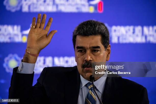 President of Venezuela Nicolas Maduro rises his hand during a meeting with the 'Consejo Nacional de Economía Productiva' at Humboldt Hotel on...