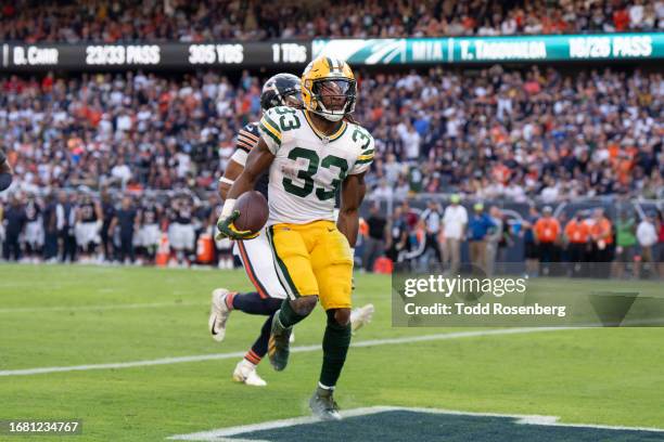 Running back Aaron Jones of the Green Bay Packers grabs his hamstring in play during an NFL football game against the Chicago Bear at Soldier Field...