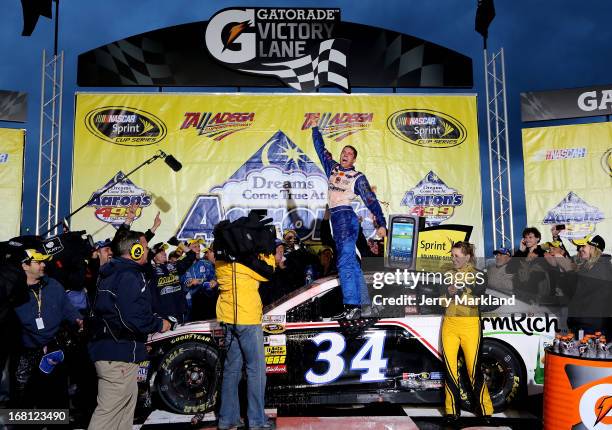 David Ragan, driver of the Farm Rich Ford, celebrates in victory lane after winning the NASCAR Sprint Cup Series Aaron's 499 at Talladega...