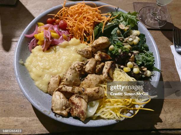 poke bowl of grilled chicken pieces, mashed potato, green salad leaves, pickled cucumber and onion, zucchini noodles, mango ceviche, cherry tomato, corn, grated carrot, nuts and lentils - mango pickle stock pictures, royalty-free photos & images