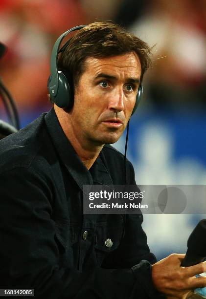 Andrew Johns commentates from the sideline for Triple M Radio during the round eight NRL match between the St George Illawarra Dragons and the Manly...