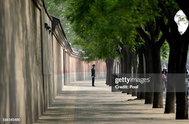 Soldier stands guard next to a red wall of the Zhongnanhai leadership compound ahead of a meeting between China's Premier Li Keqiang and Palestinian...