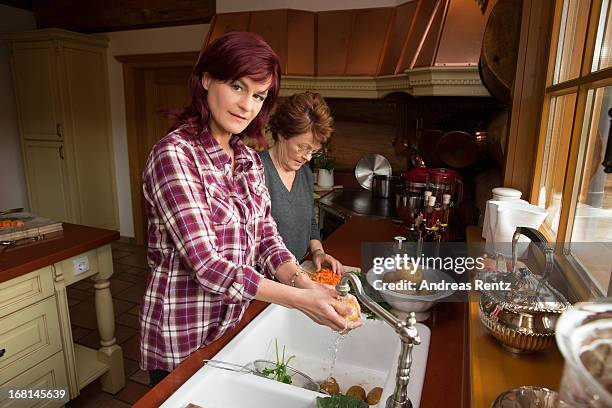 Singer Andrea Berg and her mother Helga Zellen clean vegetables on April 23, 2013 in Stuttgart, Germany. Berg's cookbook 'Meine Seelenkueche' will be...