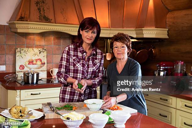 Singer Andrea Berg and her mother Helga Zellen clean vegetables on April 23, 2013 in Stuttgart, Germany. Berg's cookbook 'Meine Seelenkueche' will be...