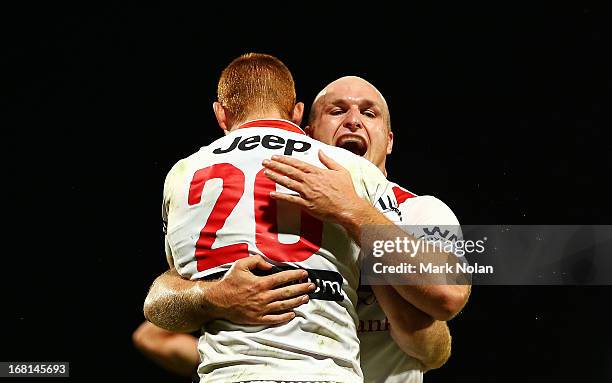 Nathan Green of the Dragons celebrates scoring a try with team mate Michael Weyman during the round eight NRL match between the St George Illawarra...