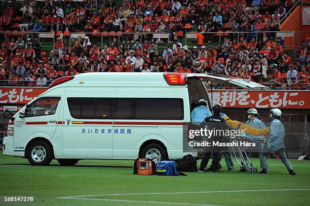 Goalkeeper Takuya Masuda of Sanfrecce Hiroshima is carried into an ambulance on a stretcher after colliding with Takamitsu Tomiyama of Omiya Ardija,...