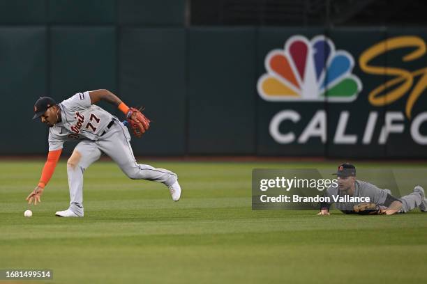 Andy Ibanez of the Detroit Tigers picks up a fly ball that Parker Meadows was not able to come up with off the bat of Aledmys Diaz of the Oakland...