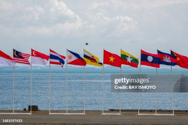 In this picture taken on September 20 flag of member nations of the Association of Southeast Asian Nations' flags are displayed at a naval base...