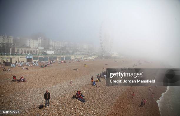 Brighton Beach is shrouded in fog on May 6, 2013 in Brighton, England. Visitors have flocked to Brighton Beach as the Met Office predicted the May...