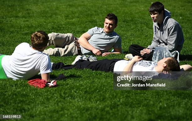 Group of boys relax in the sun in the Pavilion Gardens on May 6, 2013 in Brighton, England. Visitors have flocked to Brighton Beach as the Met Office...