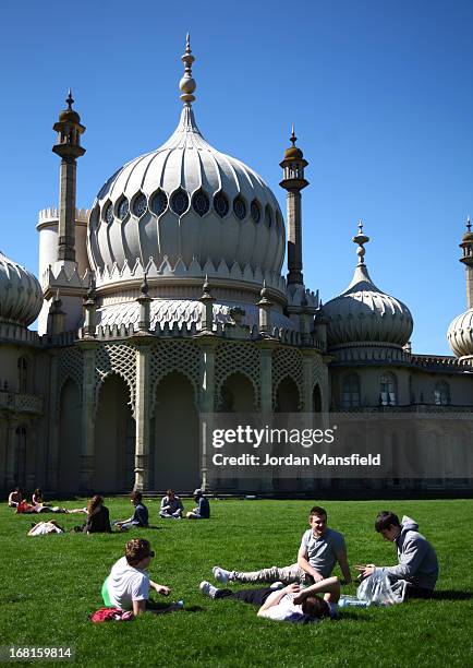 Group of boys relax in the sun in the Pavilion Gardens on May 6, 2013 in Brighton, England. Visitors have flocked to Brighton Beach as the Met Office...