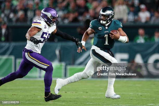 Jalen Hurts of the Philadelphia Eagles runs with the ball against Jordan Hicks of the Minnesota Vikings during the first half at Lincoln Financial...