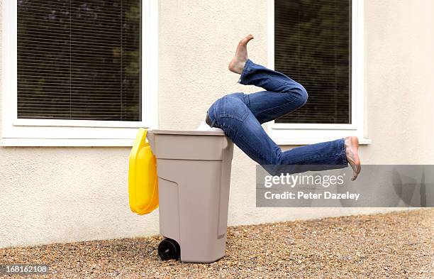 boy diving into recycling bin - dustbin stock pictures, royalty-free photos & images