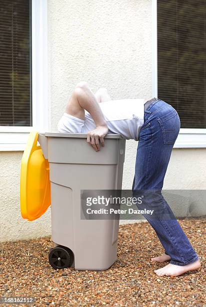boy with head in recycling bin - funny fail stock pictures, royalty-free photos & images