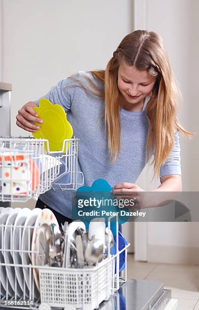 12 year old girl filling up dishwasher - 12 year old blonde girl ストックフォトと画像