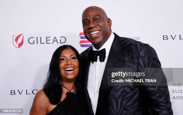 Cookie Johnson and US businessman and former basketball player Magic Johnson arrive for the Elizabeth Taylor Ball to End AIDS, at The Beverly Hills...