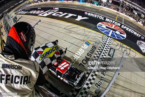 Corey Heim, driver of the Safelite Toyota, takes the checkered flag to win the NASCAR Craftsman Truck Series UNOH 200 presented by Ohio Logistics at...