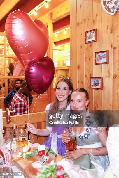 Alana Siegel and Cheyenne Ochsenknecht during the Madlwiesn at Oktoberfest at Schuetzenfestzelt on September 21, 2023 in Munich, Germany.