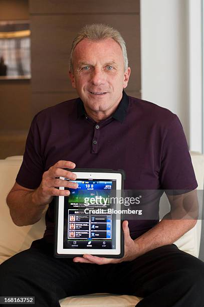 Joseph "Joe" Montana, co-founder of iMFL and retired National Football League quarterback, holds an Apple Inc. IPad with the iMFL game displayed as...