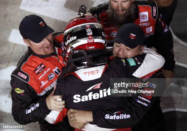 Corey Heim, driver of the Safelite Toyota, celebrates with his crew after winning the NASCAR Craftsman Truck Series UNOH 200 presented by Ohio...