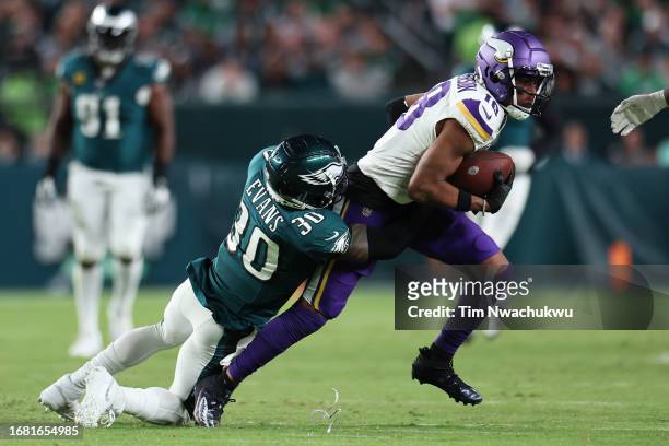 Justin Evans of the Philadelphia Eagles tackles Justin Jefferson of the Minnesota Vikings during the second half at Lincoln Financial Field on...
