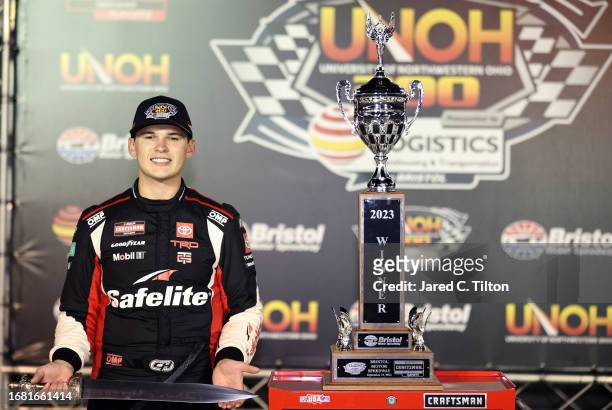 Corey Heim, driver of the Safelite Toyota, celebrates in victory lane after winning the NASCAR Craftsman Truck Series UNOH 200 presented by Ohio...