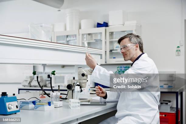 man working in laboratory - three quarter length stock pictures, royalty-free photos & images