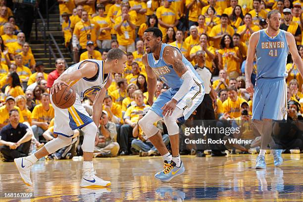 Andre Iguodala of the Denver Nuggets defense Stephen Curry of the Golden State Warriors in Game Six of the Western Conference Quarterfinals during...