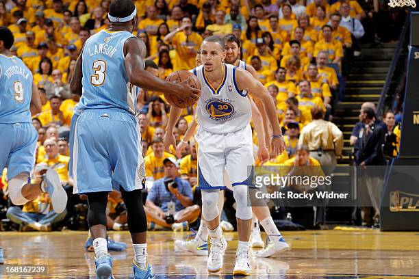 Stephen Curry of the Golden State Warriors defends Ty Lawson of the Denver Nuggets in Game Six of the Western Conference Quarterfinals during the...