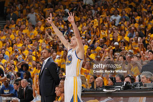 David Lee of the Golden State Warriors signals a three after his teammate makes a three pointer against the Denver Nuggets in Game Six of the Western...