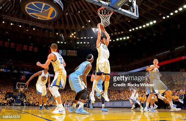 Andrew Bogut of the Golden State Warriors rebounds against the Denver Nuggets in Game Six of the Western Conference Quarterfinals during the 2013 NBA...