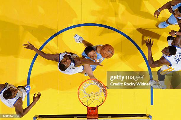 Andre Miller of the Denver Nuggets shoots against Harrison Barnes of the Golden State Warriors in Game Six of the Western Conference Quarterfinals...