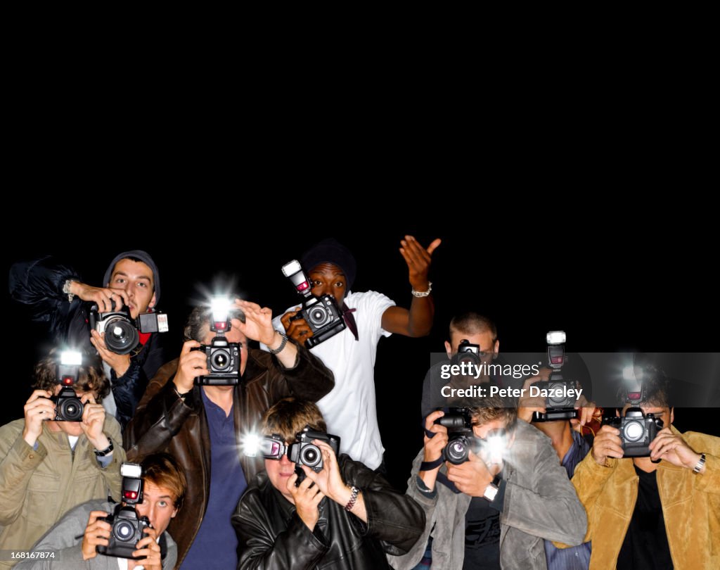 Line of paparazzi photographers with copy space