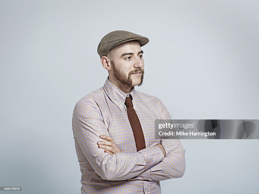 Man wearing retro clothing looking to side.