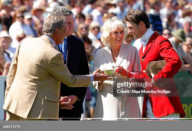 Camilla, Duchess of Cornwall presents Harry Meade with a trophy during the prize giving ceremony at the Badminton Horse Trials on May 6, 2013 in...