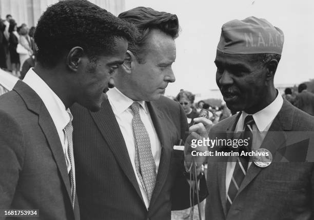 Left to right, African American singer Sammy Davis Jr , listens as American journalist Merrill Mueller interviews National Association for the...