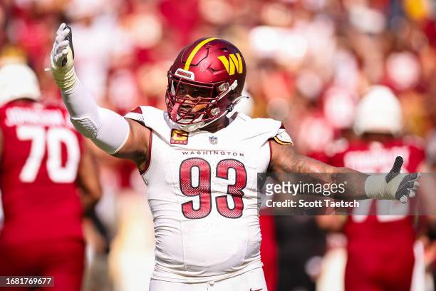 Jonathan Allen of the Washington Commanders celebrates after a play against the Arizona Cardinals during the second half of the game at FedExField on...
